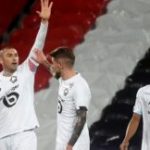 Lille’s Trukish midefielder Burak Yilmaz (L) in celebrations after he scores a goal during the French L1 football match between Lens and Lille LOSC at the Bollaert Stadium, which took place in Lens, northern France, on May 7, 2021. (Photo by FRANCOIS LO PRESTI / AFP)